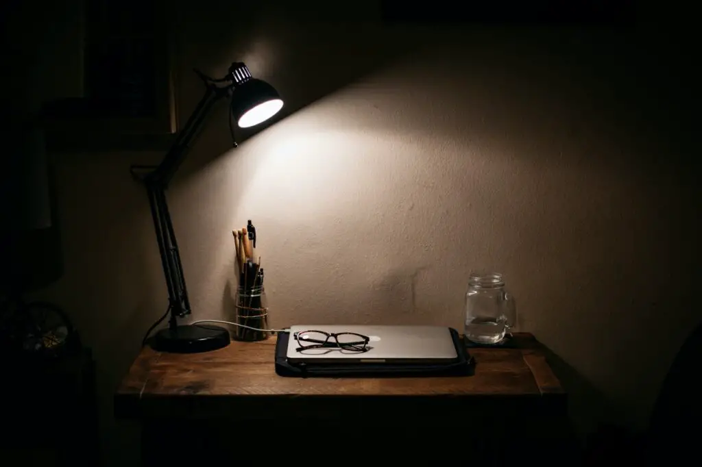 studying in the dark with a desk lamp